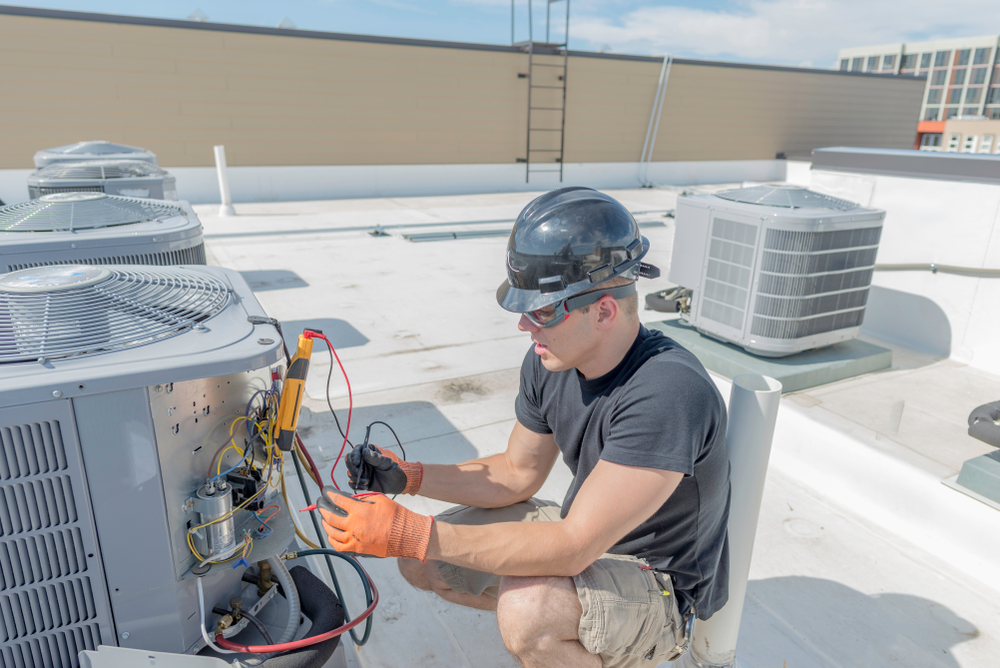 Hvac,Tech,Holding,A,Volt,Meter,,Working,On,A,Condensing
